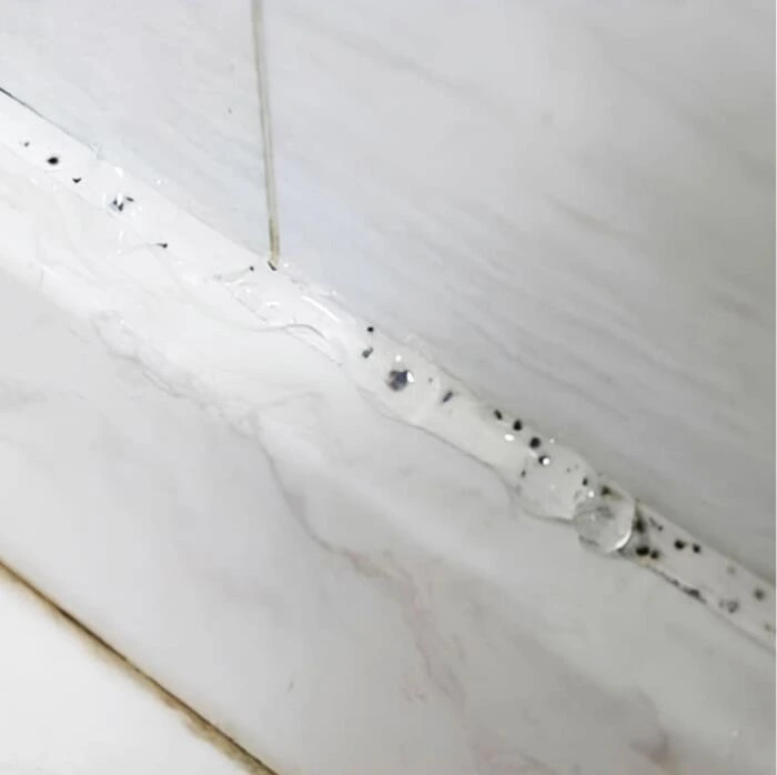nuroclean-gel-working-on-mold-grout Applying NuroClean mold removal gel to moldy bathroom grout